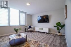 Living area featuring a textured ceiling and wood finished floors - 
