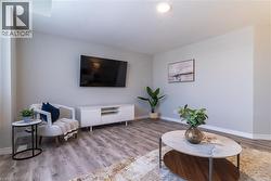 Living area with wood finished floors and a textured ceiling - 