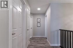 Hall featuring wood finished floors and baseboards - 