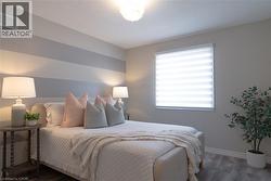 Bedroom with wood finished floors and baseboards - 