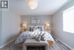 Bedroom with wood finished floors and baseboards - 