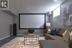 Cinema with wood finished floors and recessed lighting - 