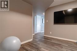 Workout room with wood finished floors and baseboards - 