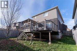 Back of property with a fenced backyard, a deck, and stairway - 