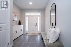 Foyer entrance featuring dark tile patterned floors and recessed lighting - 
