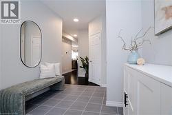 Entrance foyer with recessed lighting and dark tile patterned floors - 