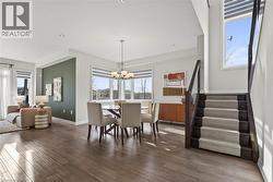 Dining area with stairway, hardwood / wood-style flooring, a chandelier, and recessed lighting - 