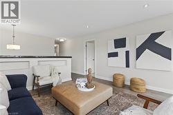 Living area with dark wood finished floors and recessed lighting - 