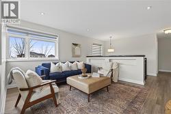 Living area with wood finished floors and recessed lighting - 