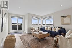 Living room featuring wood finished floors, healthy amount of natural light, and recessed lighting - 