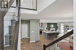 Stairway with wood finished floors, a textured ceiling, and a fireplace - 