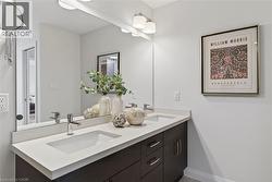 Full bathroom featuring double vanity and baseboards - 