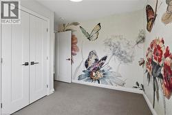 Unfurnished bedroom featuring carpet flooring and a closet - 