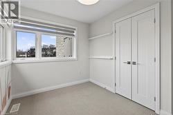 Unfurnished bedroom featuring carpet flooring and a closet - 