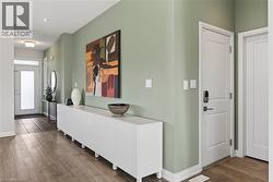 Entryway featuring dark wood-style flooring and baseboards - 