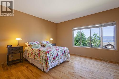 Main level primary bedroom - 610 Arrowleaf Lane, Kelowna, BC - Indoor Photo Showing Bedroom