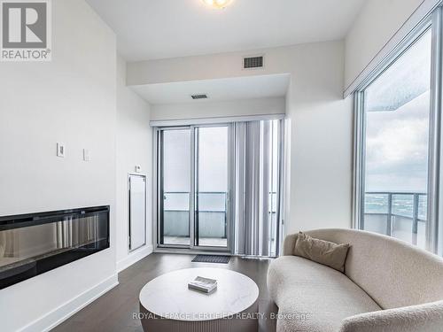 4701 - 20 Shore Breeze Drive, Toronto, ON - Indoor Photo Showing Living Room With Fireplace