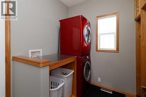 You can easily remove the counter if you want to unstack the washer and dryer - 247 Mt Selkirk Close Se, Calgary, AB - Indoor Photo Showing Laundry Room