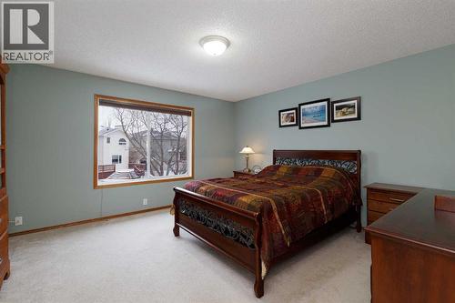 Your primary bedroom easily fits a king sized bed - 247 Mt Selkirk Close Se, Calgary, AB - Indoor Photo Showing Bedroom