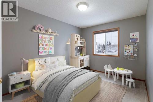 Virtually staged kids bedroom to how you how nicely their furnitute will fit - 247 Mt Selkirk Close Se, Calgary, AB - Indoor Photo Showing Bedroom