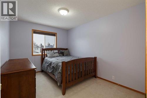 The 3rd family bedroom has a queen bed in it - 247 Mt Selkirk Close Se, Calgary, AB - Indoor Photo Showing Bedroom