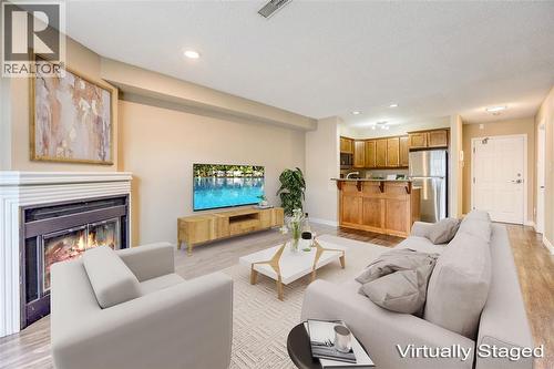 1520 Venetian Boulevard Unit# M108, Point Edward, ON - Indoor Photo Showing Living Room With Fireplace