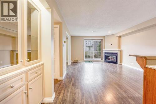1520 Venetian Boulevard Unit# M108, Point Edward, ON - Indoor Photo Showing Living Room With Fireplace