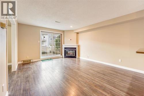 1520 Venetian Boulevard Unit# M108, Point Edward, ON - Indoor Photo Showing Living Room With Fireplace