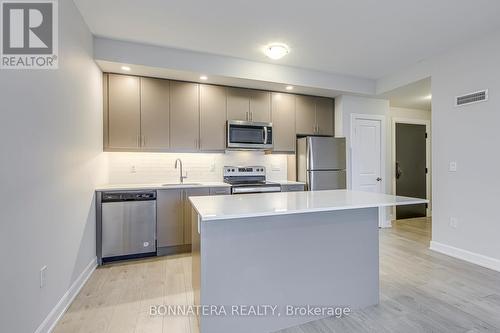 408 - 3200 William Coltson Avenue, Oakville, ON - Indoor Photo Showing Kitchen With Stainless Steel Kitchen