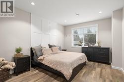 Bedroom with wood finished floors and recessed lighting - 