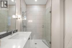 Bathroom with vanity and a shower stall - 