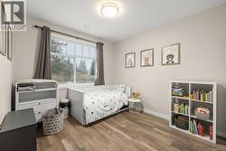 Bedroom with wood finished floors and baseboards - 