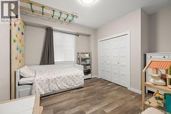 Bedroom featuring wood finished floors and a closet - 
