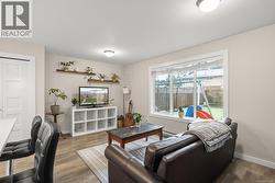 Suite Living area featuring wood finished floors and a baseboard radiator - 