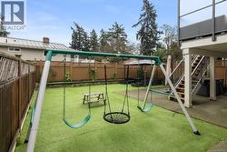 View of fenced backyard and a patio area - 