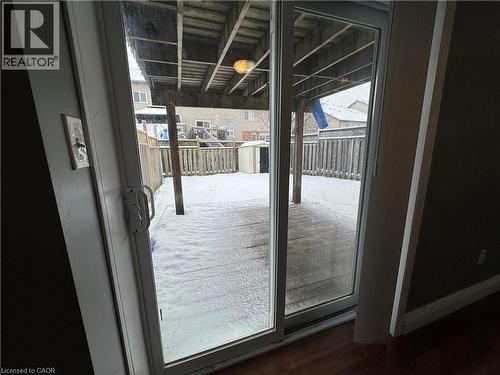 Doorway to outside with plenty of natural light and wood finished floors - 211 Snowdrop Crescent Unit# Lower, Kitchener, ON - Indoor Photo Showing Other Room
