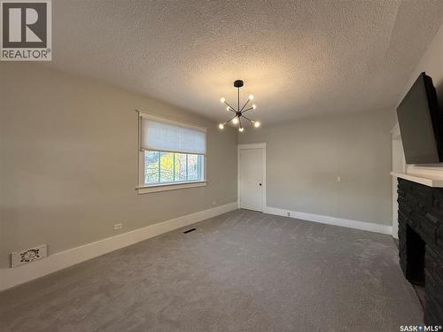 111 5Th Avenue E, Kindersley, SK - Indoor Photo Showing Other Room With Fireplace