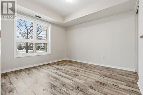 Bedroom with south-facing windows - 107 - 1045 Nadalin Heights, Milton, ON - Indoor Photo Showing Other Room