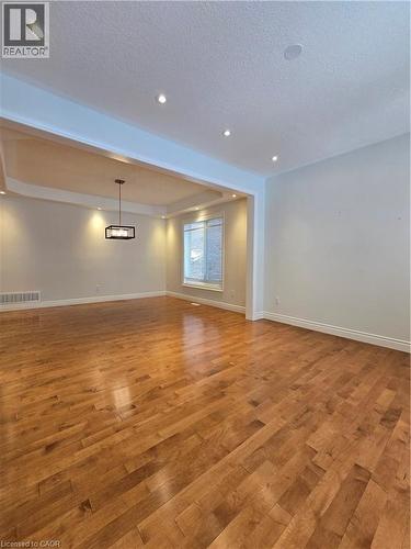 Unfurnished room featuring light wood finished floors, a textured ceiling, and recessed lighting - 93 Tremaine Drive, Kitchener, ON - Indoor Photo Showing Other Room