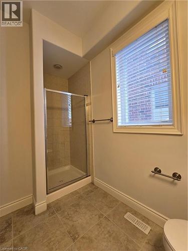 Full bath with a stall shower and light tile patterned floors - 93 Tremaine Drive, Kitchener, ON - Indoor Photo Showing Bathroom