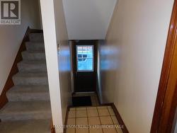 SIDE DOOR ENTRANCE AND STAIRS TO UPPER FLOOR - 