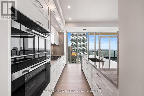 Chef Kitchen W Stone Counter top and backsplash - 3204 - 10 Inn On The Park Drive, Toronto, ON - Indoor Photo Showing Kitchen With Upgraded Kitchen