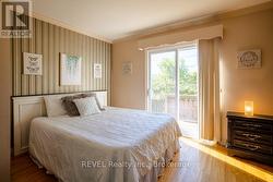 The primary bedroom with a walkout to the deck. - 