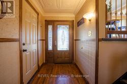 The entryway features a beautiful tin ceiling. - 