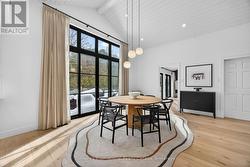 Dining area overlooking forested lot - 