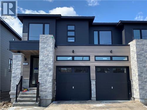 Modern home with stone siding and an attached garage - 49 Eberhardt Drive, Wasaga Beach, ON - Outdoor