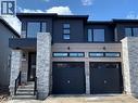 Modern home with stone siding and an attached garage - 49 Eberhardt Drive, Wasaga Beach, ON  - Outdoor 