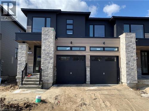 Contemporary home with stone siding, concrete driveway, and an attached garage - 49 Eberhardt Drive, Wasaga Beach, ON - Outdoor