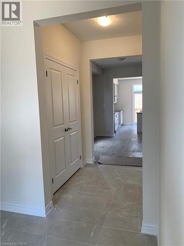 Corridor featuring baseboards and light marble finish floors - 49 Eberhardt Drive, Wasaga Beach, ON - Indoor Photo Showing Other Room