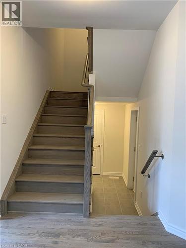 Staircase featuring baseboards and wood finished floors - 49 Eberhardt Drive, Wasaga Beach, ON - Indoor Photo Showing Other Room